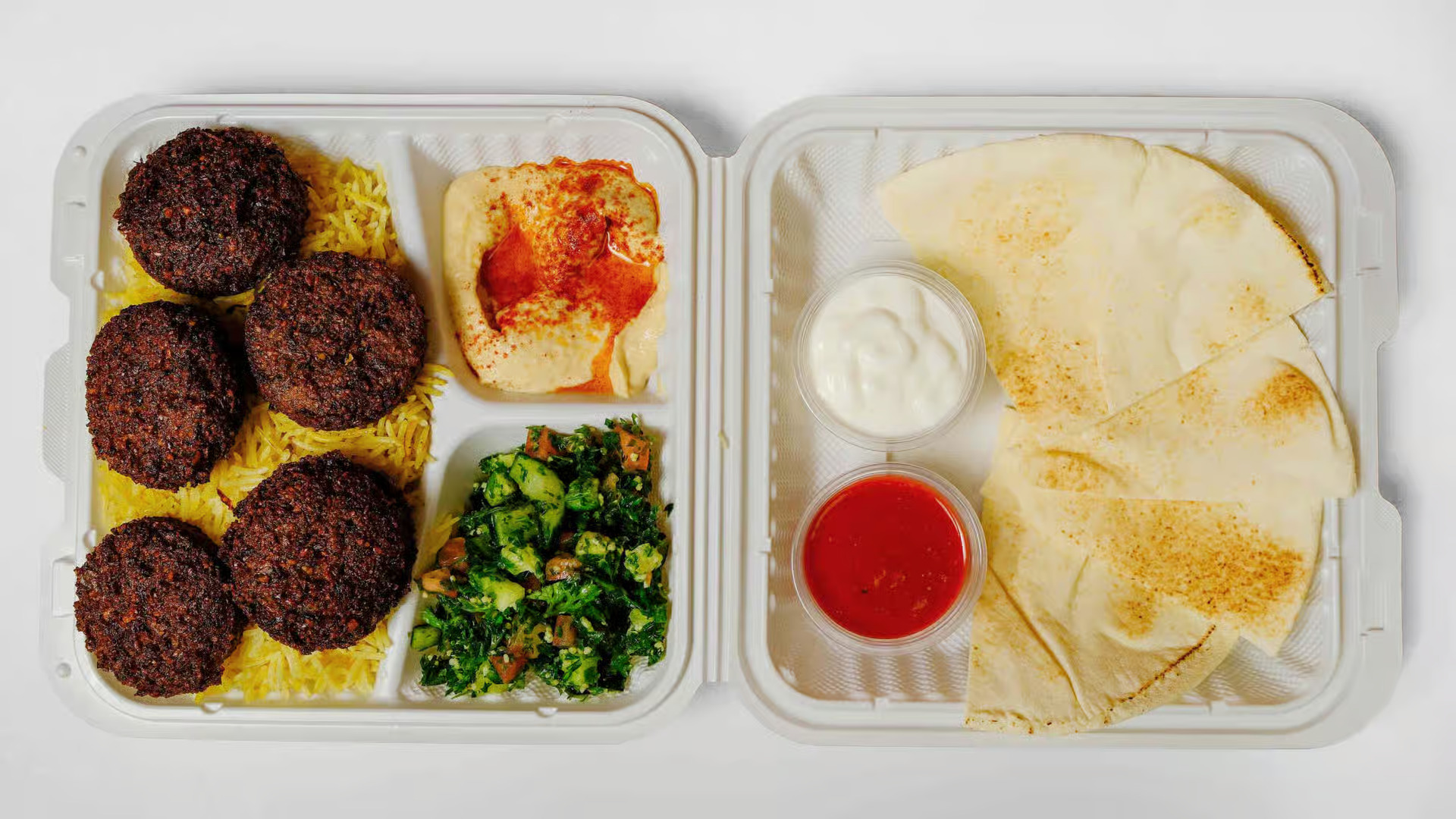Falafel Plate - Crispy golden falafel balls served with rice, fresh salad, hummus, and tahini sauce